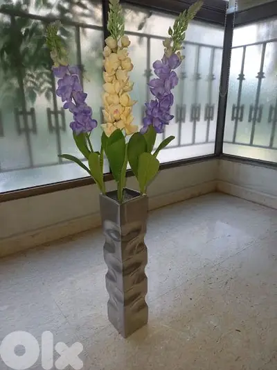Silver pot with artificial flowers