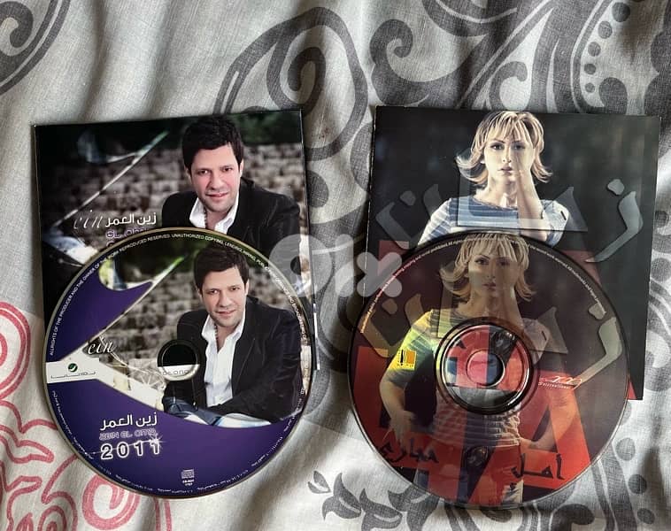 two cds original with no cover : zein el omor& amal hijazi both 5 $ 0