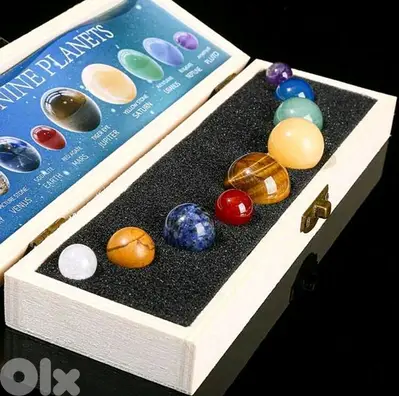 collection of 9 planets of gem stones in a wood box