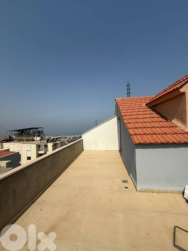 A furnished rooftop apartment with terrace in Awkar. 0
