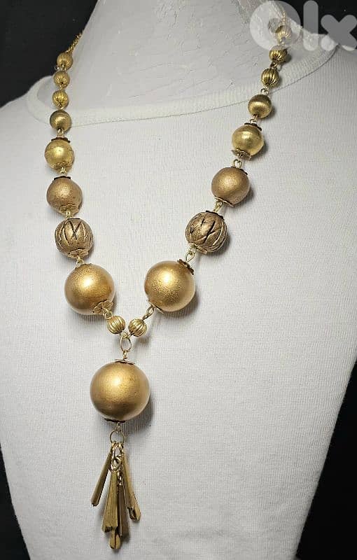 10$ gold-tone statement necklace with brass bead 0