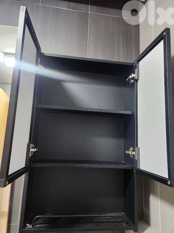 bathroom storage box with a black mirror door. 0