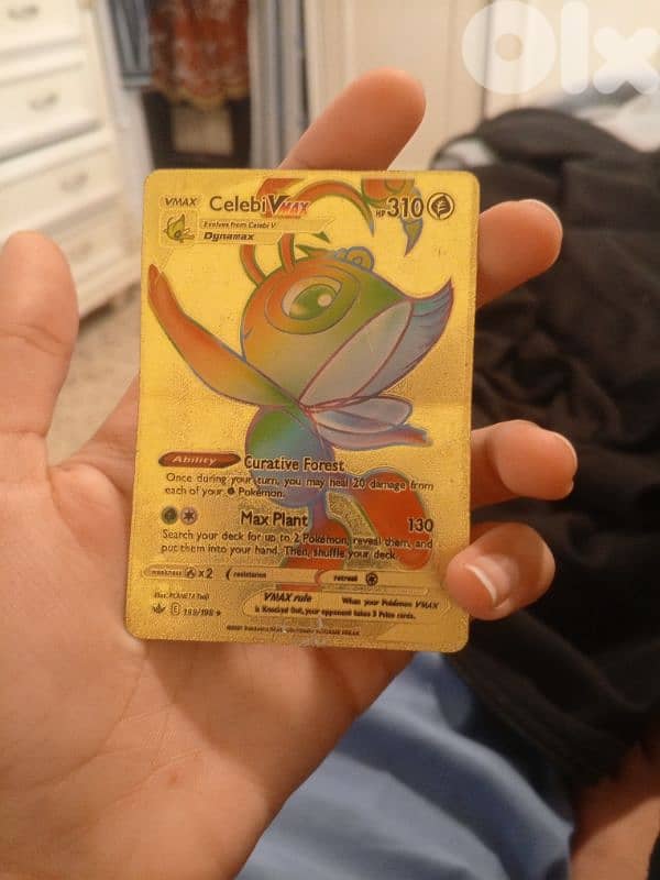 a gold metal card celebi 0