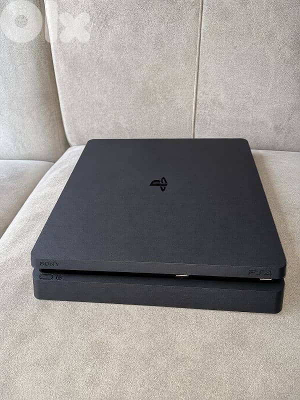 ps4 slim in great condition used 1tb working 100% 2 controllers 0