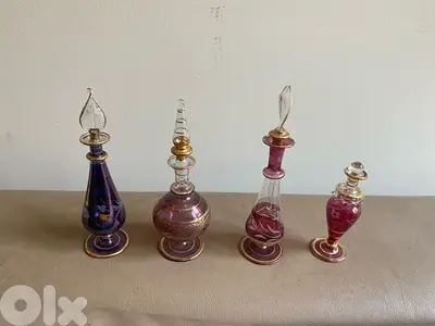 four miniature perfume bottles