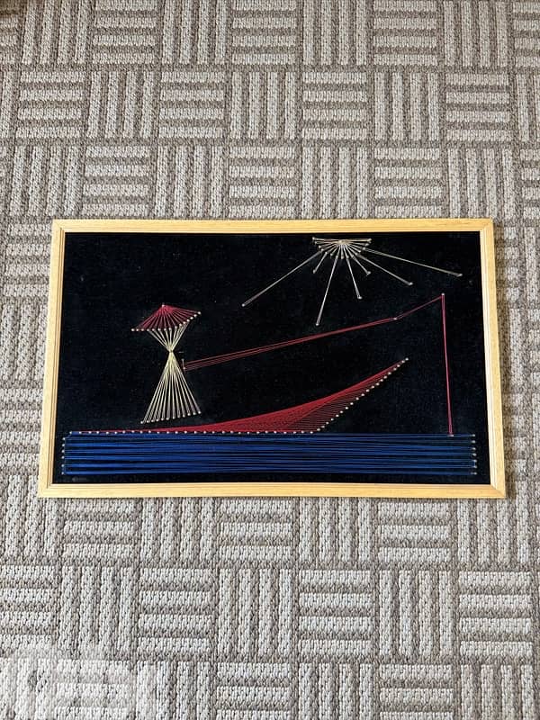 Vintage handmade string art wall decor on black velvet background 0