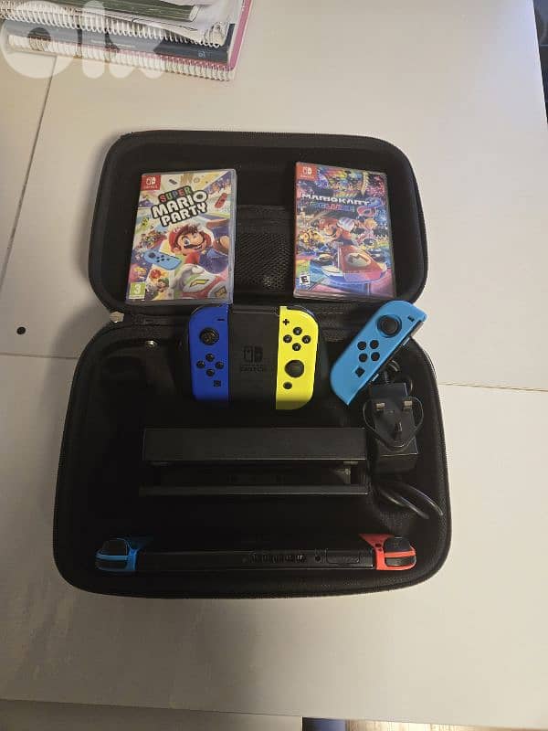 nintendo switch + 5 controllers + mario party game and mariokart 8 0