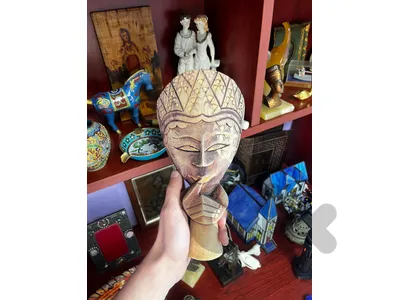 A stamped batik wooden mask, hand-carved from Indonesia.