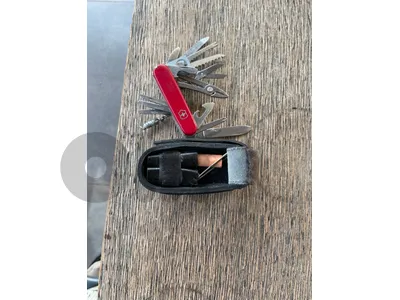 Victorinox SwissChamp SOS Kits, which bundled the knife in an expanded pouch with survival tools like a compass, plasters, and string. The kits featured three main configurations: a red (1.6795) Swiss