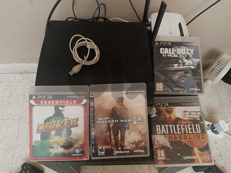 ps3 with 3 controllers and 4 cds