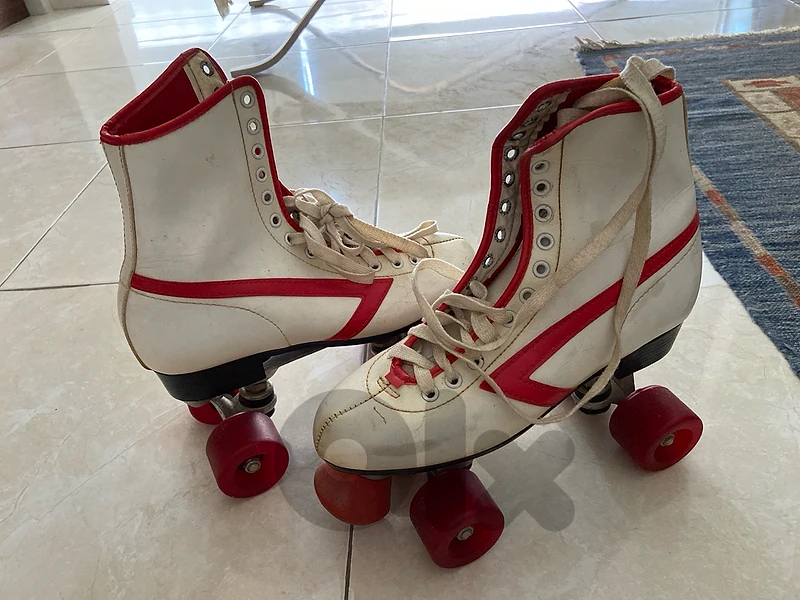 Vintage used red and white rollerskates