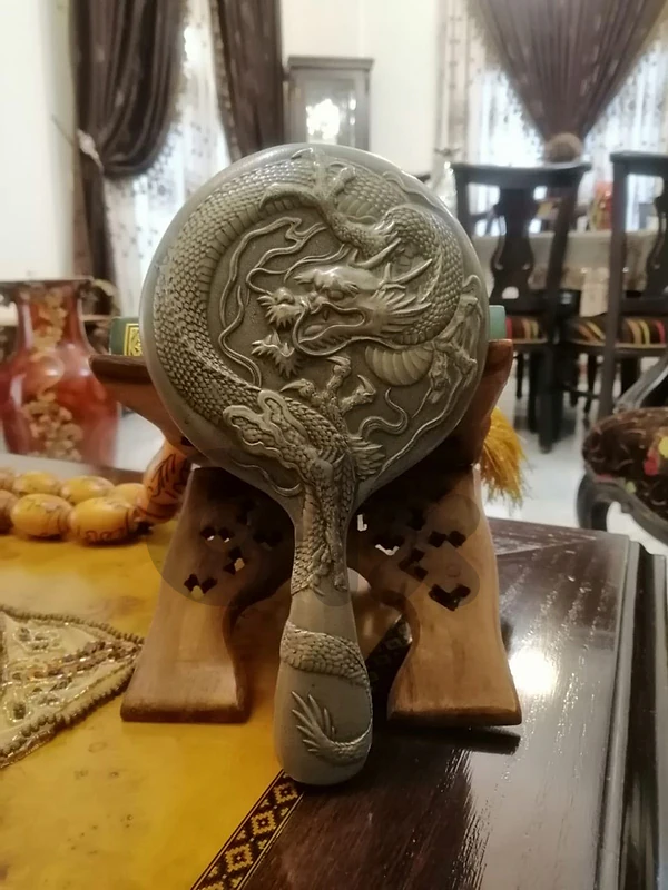 an antique handled Chinese silver mirror from the 19th century