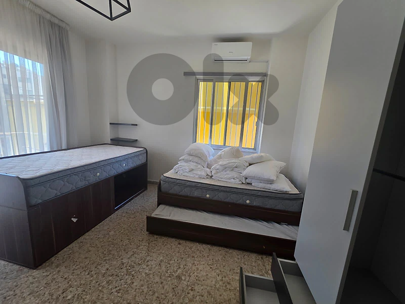 two beds with closet and desk