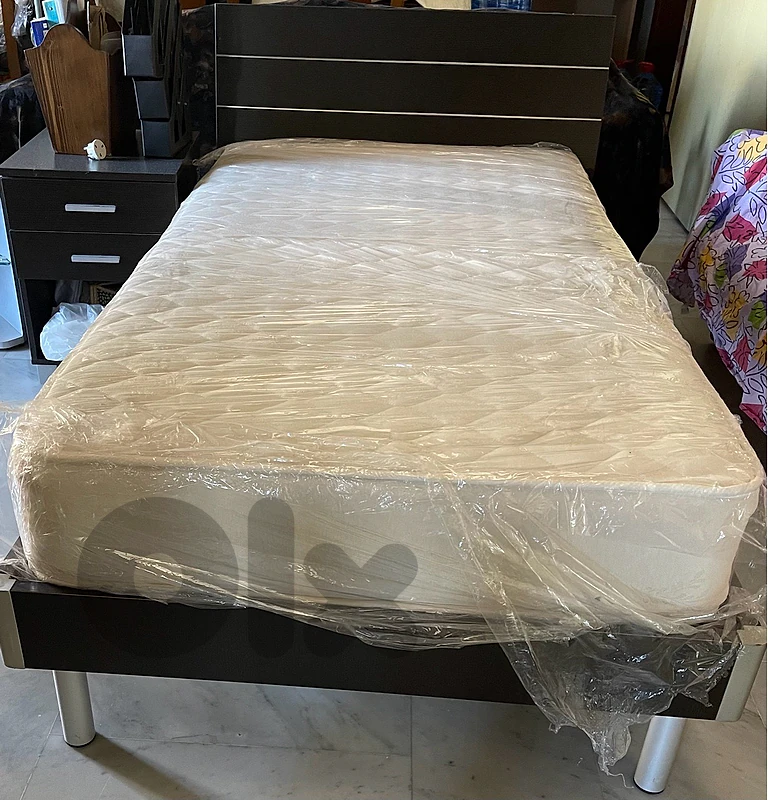 bed with mattress and side table