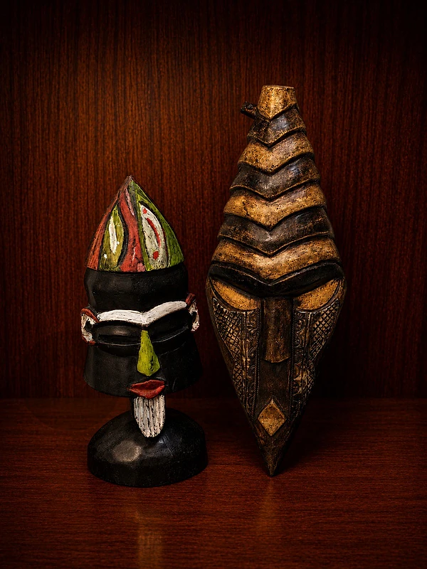 2 Handcrafted Ghanaian wooden masks.