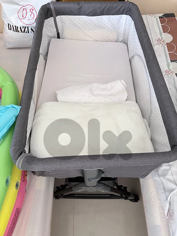 portable bed new with     mattress and a bedspread.