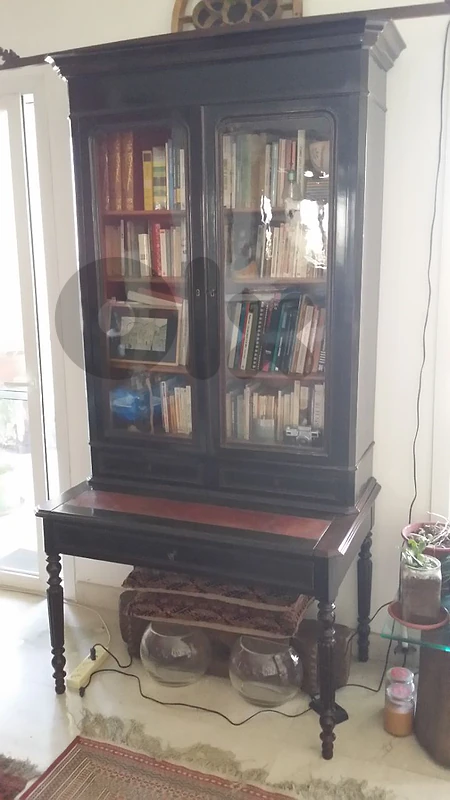 A french cabinet bookshelves with a retractable table.