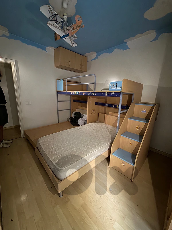 bedroom with 3 beds and closets