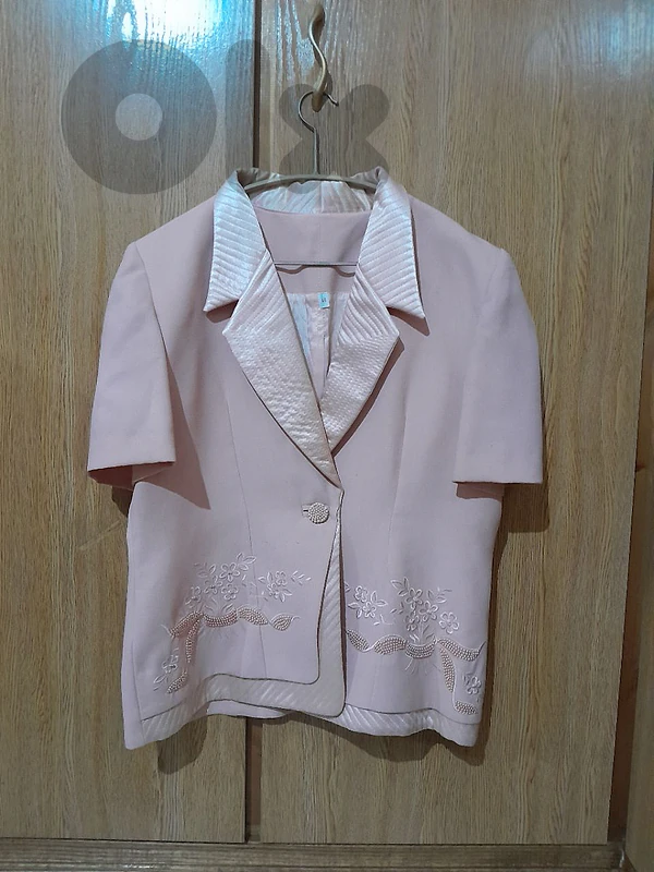wedding outfit with a pink jacket, skirt, and top