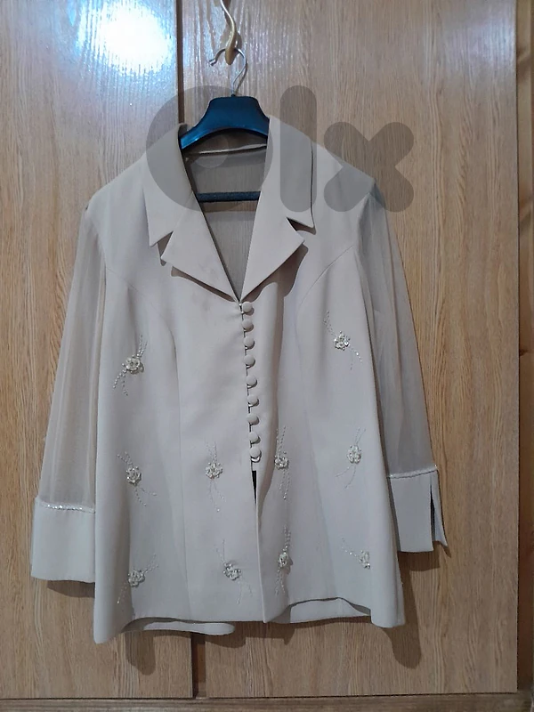 wedding outfit with a beige jacket, skirt, and top