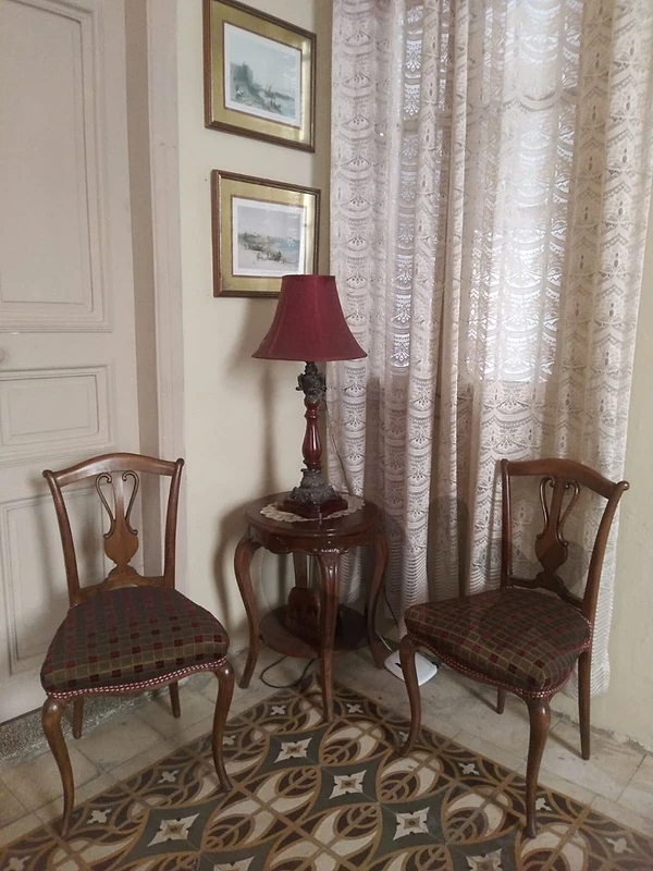 2 chairs 1 little table lamp