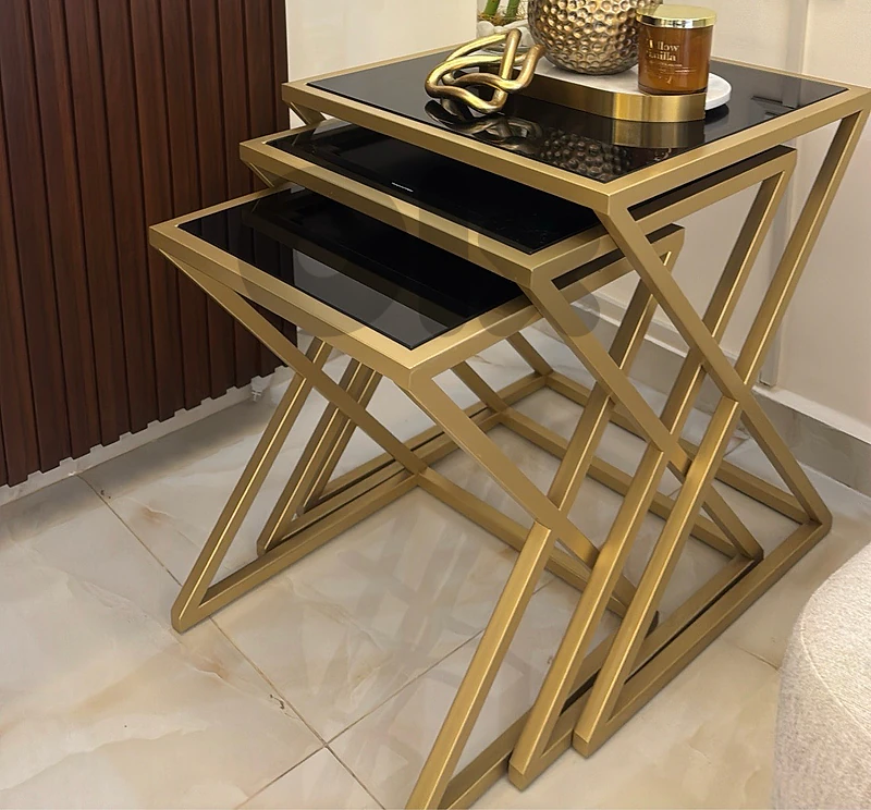 3 piece gold metal and black glass side table set