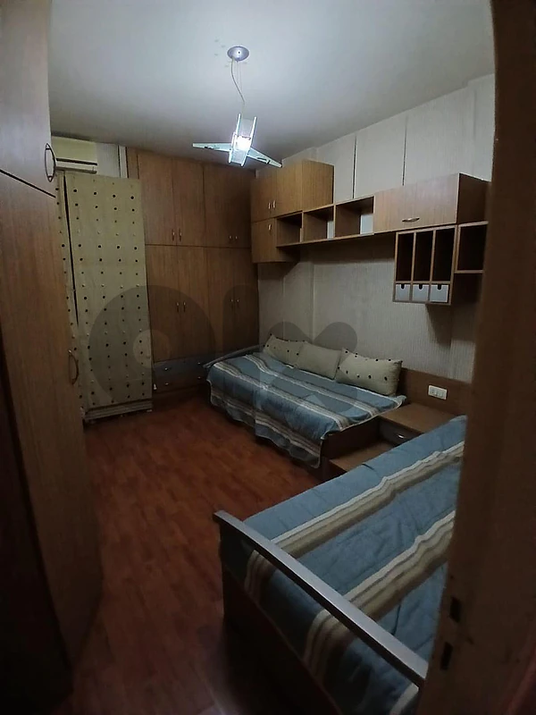 closet with 2 small beds