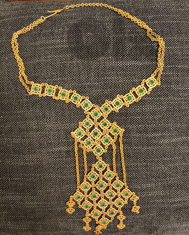 Gold-tone statement necklace with green stones