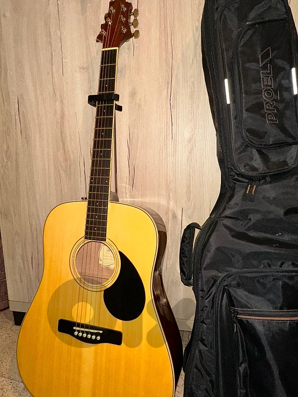 Acoustic guitar with bag and capo