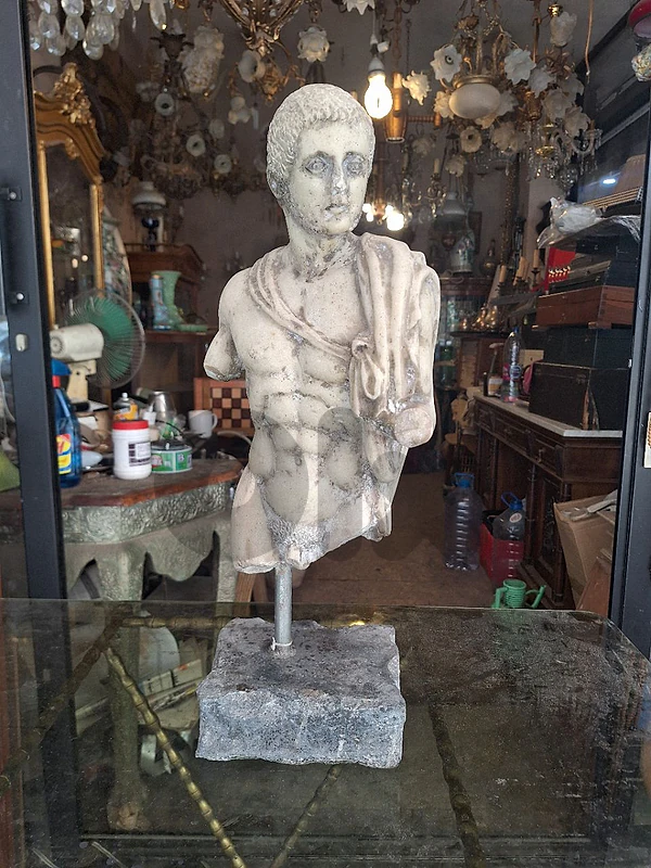 marble torso bust of a male youth sculpted in the classical roman
