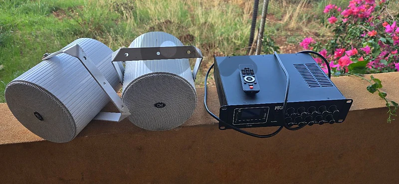 Two outdoor speakers and amplifier