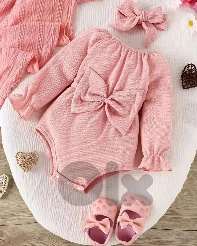 Soft ribbed pink romper with a cute oversized bow on the front.