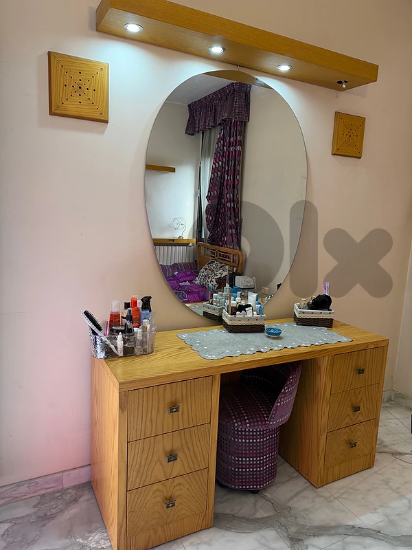 vanity with mirror and chair and lights