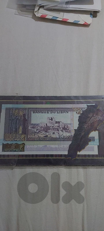 Ten thousand lira violet UNC lebanese banknote in cadre of Lebanon map
