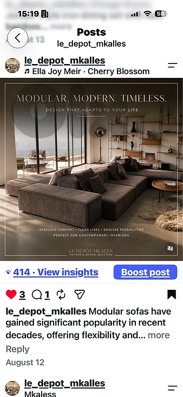 A modern, dark grey modular sectional sofa with throw pillows.