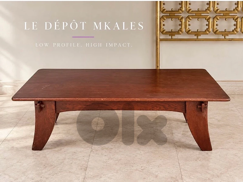 A vintage solid wood low coffee table with splayed legs.