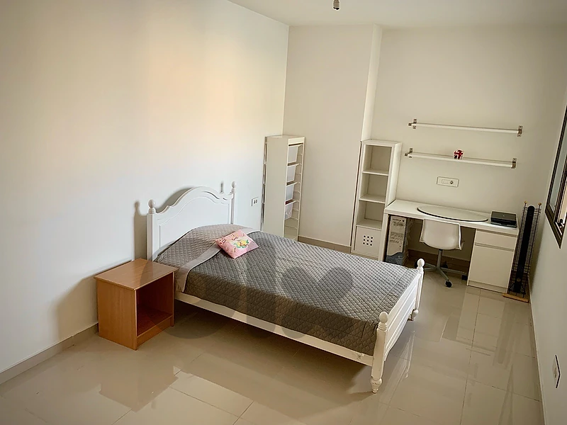 Bedroom with 2 beds and desk