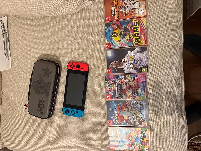 nintendo switch 1 with 6 games and a mario kart case