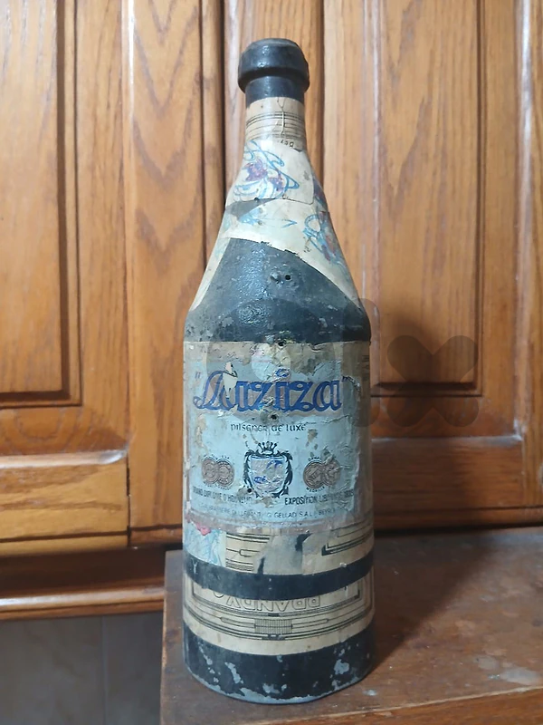 old metal bottle with many vintage label