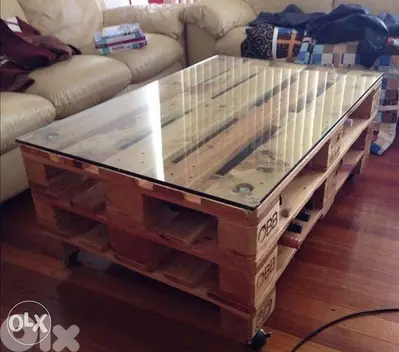 Glass ans wood and tires coffe table طاولة وسط مع مجه زجاج ودواليب