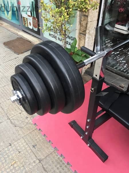 bench adjustable with adjustable rack with axe and weights all new 4