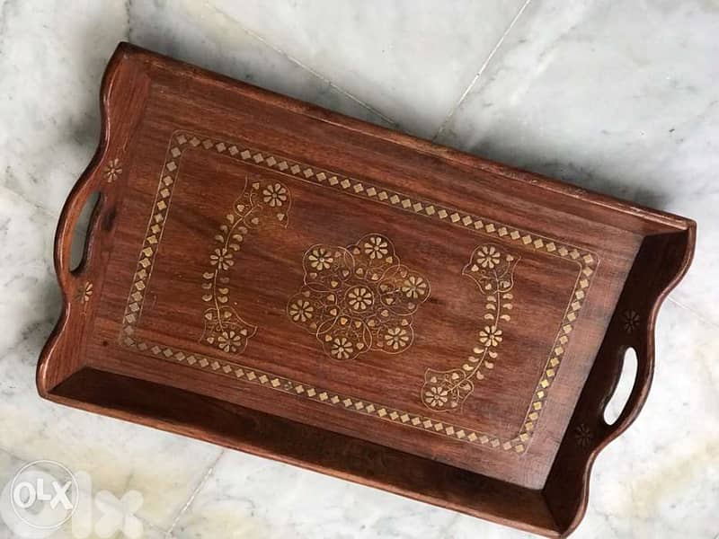 Wooden Tray with brass design pieces on it 0